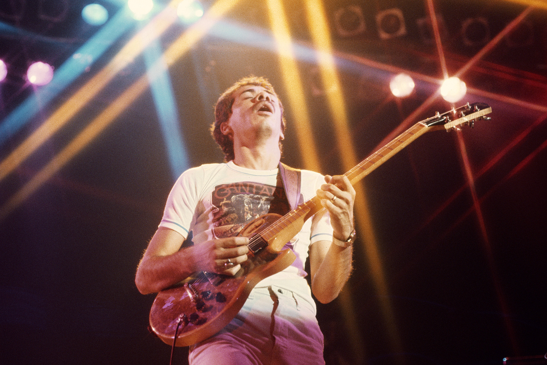 Carlos Santana performing in 1975, showcasing his fusion of Latin, blues, and jazz guitar styles