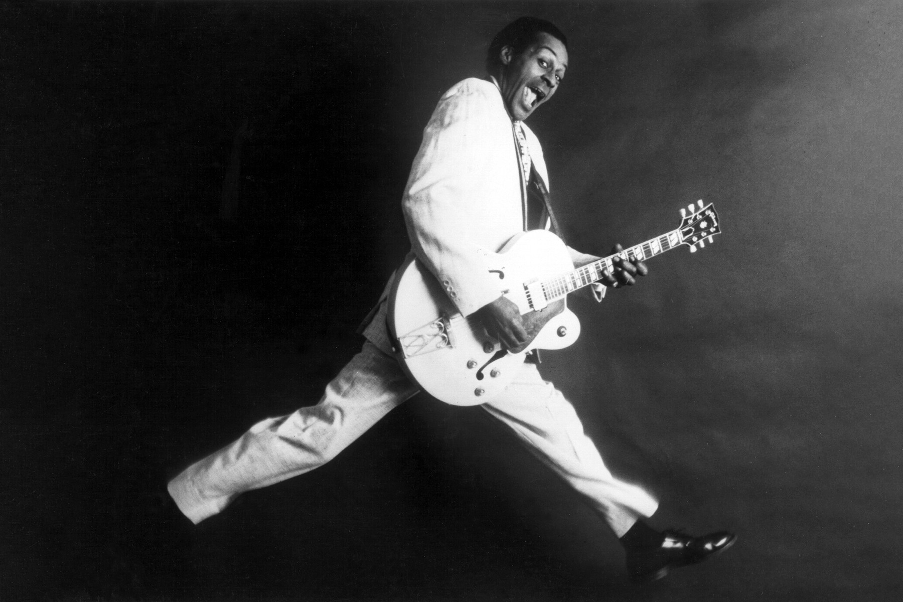 Chuck Berry posing with his Gibson guitar in 1958, inventing rock and roll guitar and defining the genre's sound