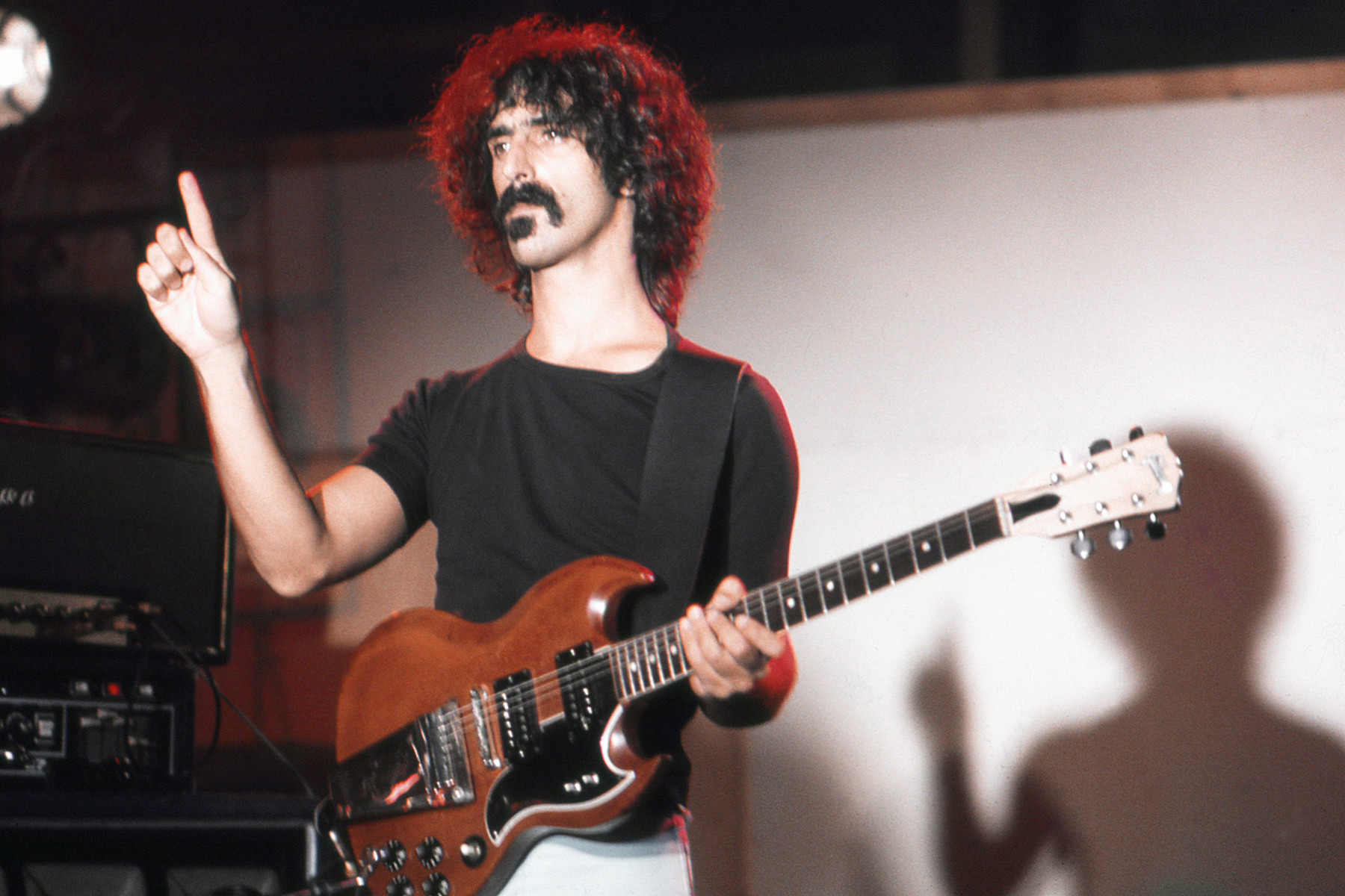 Frank Zappa in his studio in Los Angeles, 1974, surrounded by his musical equipment and showcasing his experimental approach