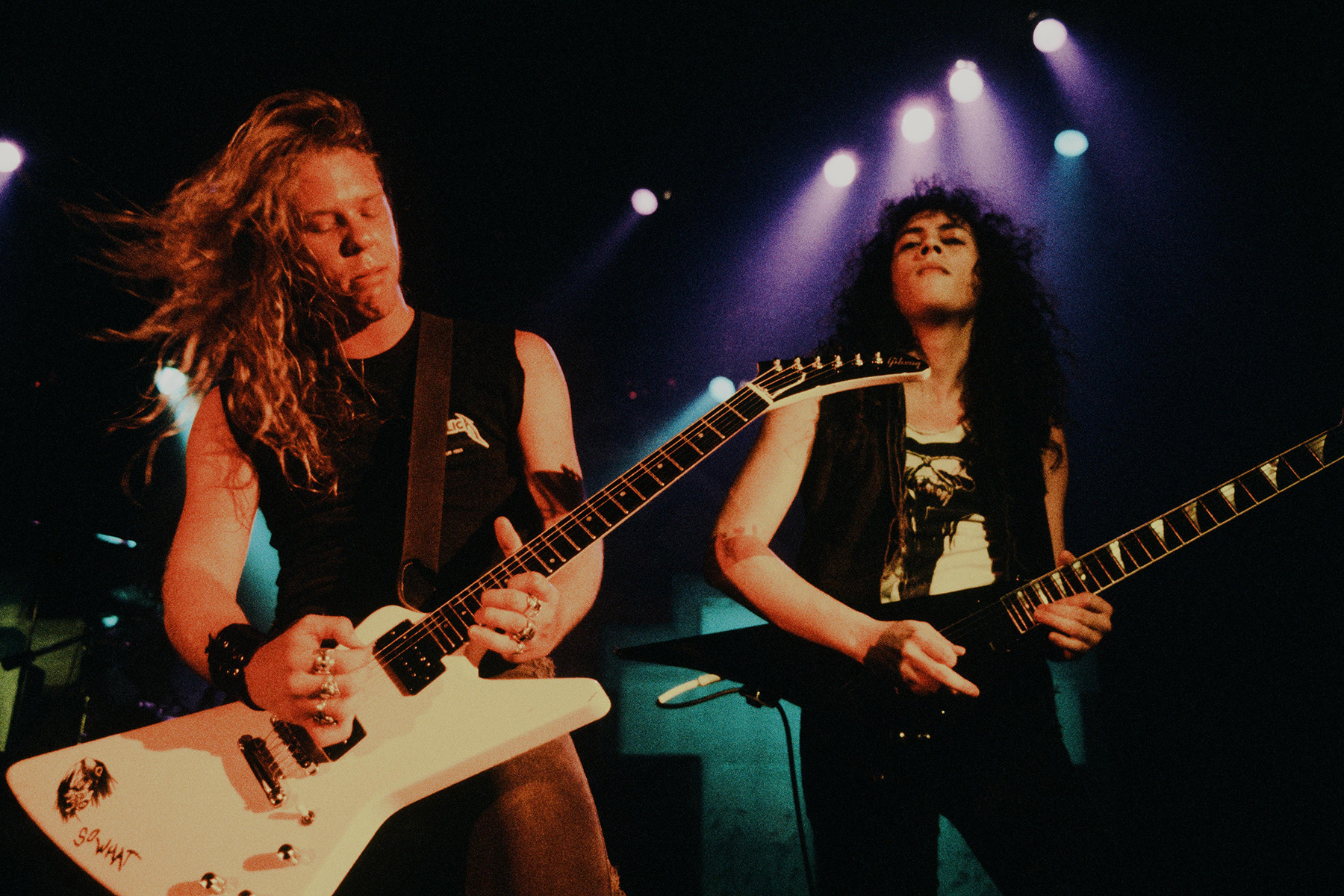 James Hetfield and Kirk Hammett of Metallica performing in Tokyo, 1986, showcasing their dual guitar attack and metal innovation