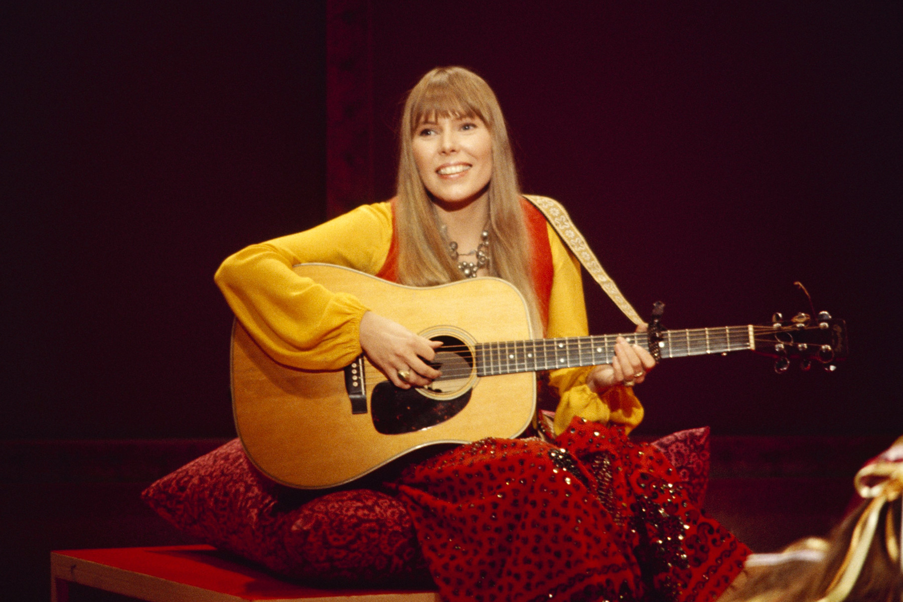 Joni Mitchell performing on The Mama Cass Television Program, 1969, showcasing her unique acoustic guitar style and alternate tunings