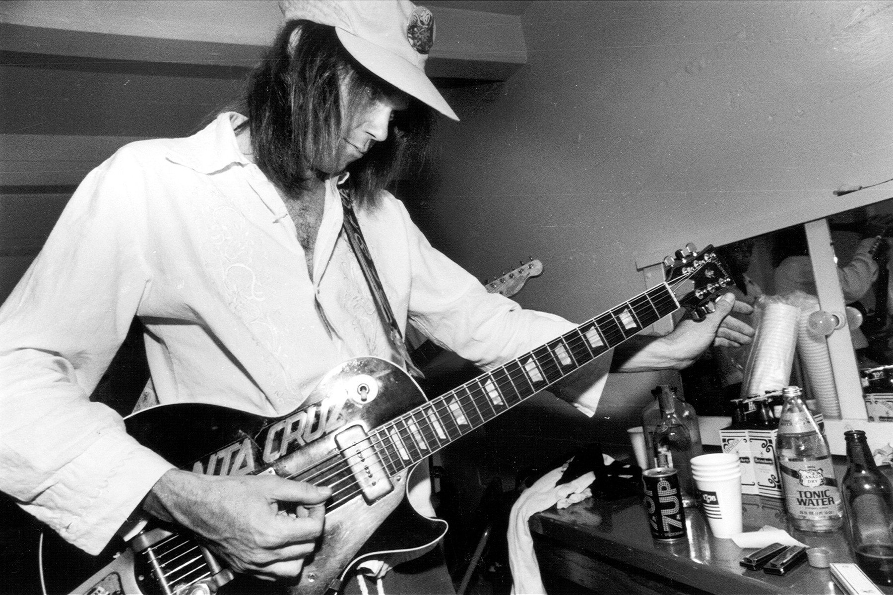 Neil Young in a portrait from circa 1970, showcasing his raw and emotional guitar style across acoustic and electric genres