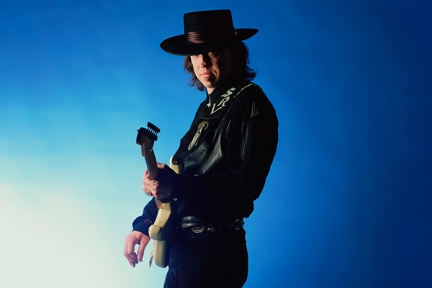 Stevie Ray Vaughan in a portrait, showcasing his powerful blues-rock guitar style and his influence on generations of guitarists