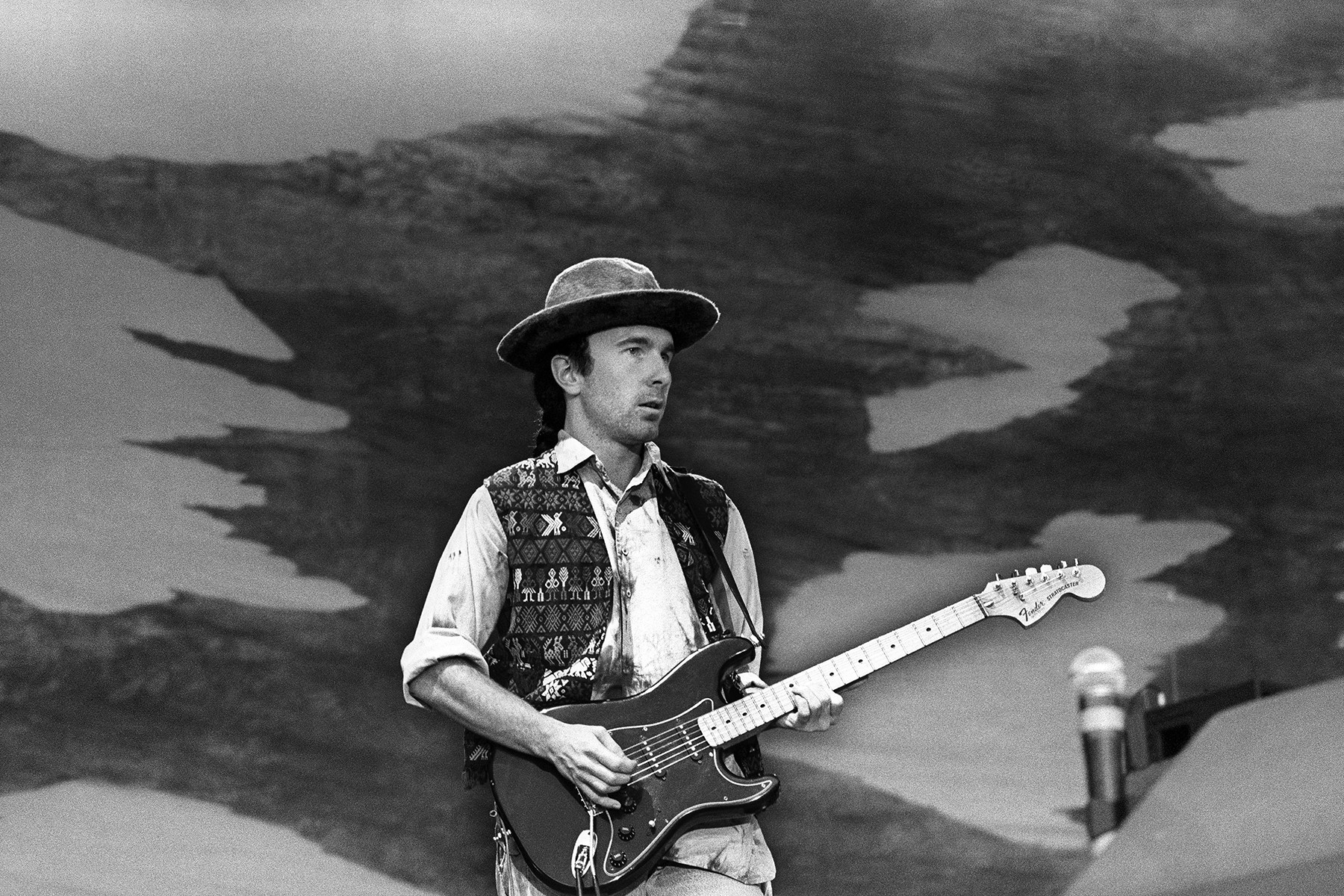 The Edge playing a Fender Stratocaster on stage during U2's Joshua Tree Tour in Rotterdam, 1987, highlighting his innovative use of effects