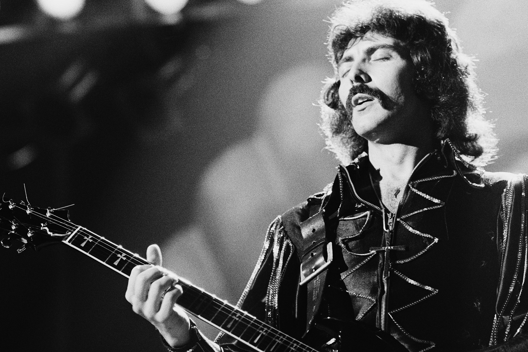 Tony Iommi of Black Sabbath performing in London, 1976, showcasing his doomy metal guitar style and his signature sound