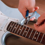 How Much Does It Cost To Restring A Guitar (What You Need To Know)