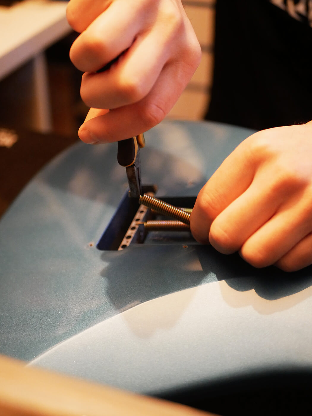 Applying fretboard oil to a guitar fretboard, showcasing the conditioning step in learning how to set up a guitar and maintain its wood.