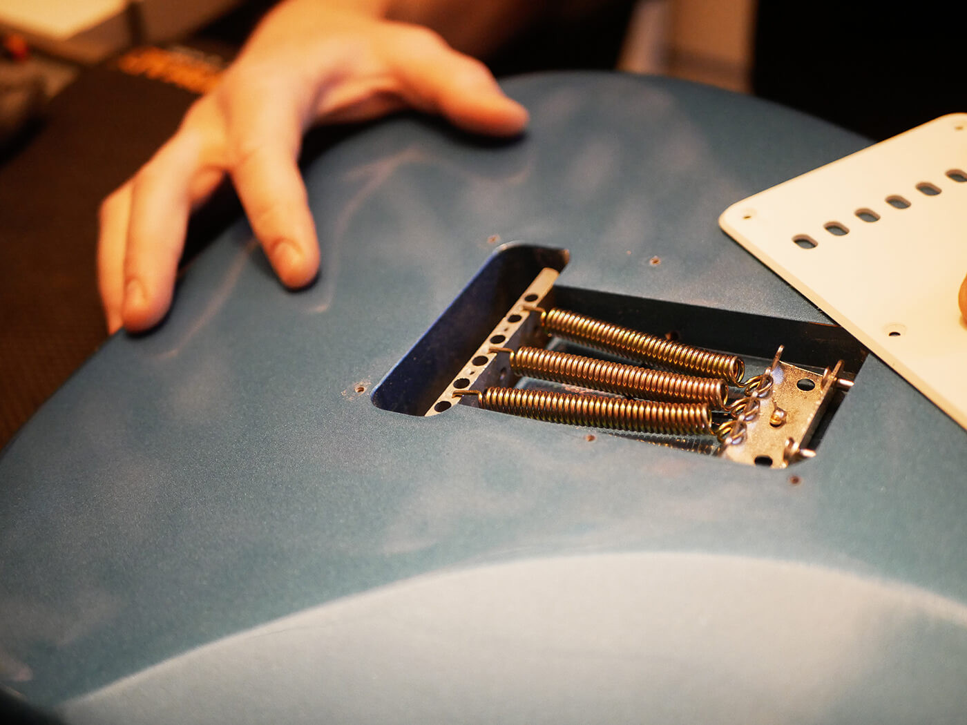Close-up of guitar setup tools laid out on a workbench, highlighting the essential items needed for a comprehensive guitar setup.