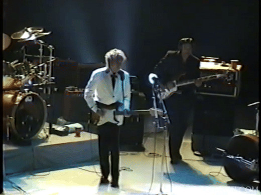 Bob Dylan machine gun audience point guitar pose