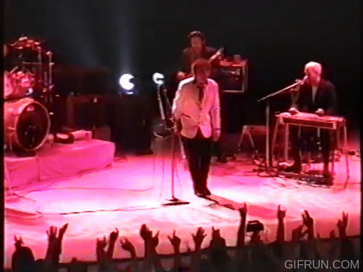 Bob Dylan show ending bow and kiss guitar pose