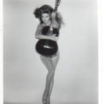 Charo promotional photo 1979 showcasing her holding a classical guitar, highlighting her musical talent beyond her cuchi-cuchi persona.