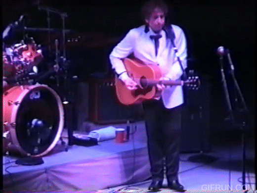Bob Dylan advanced knee bend guitar pose with head shake