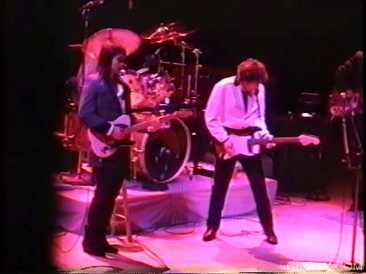 Bob Dylan spread-legged locked-knee power stance guitar pose