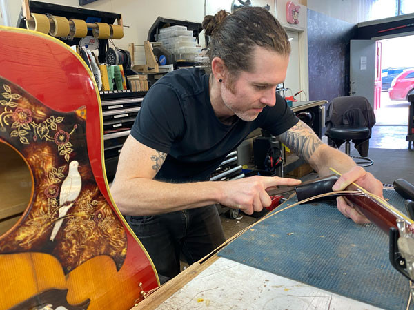Dry fitting the neck joint on the Gibson Dove before gluing