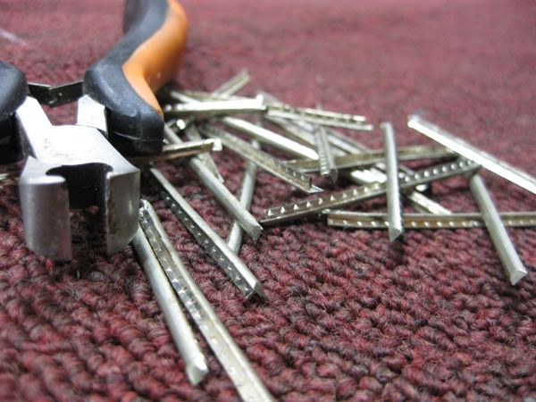 A pile of removed frets, symbolizing the transformation from fretted to fretless