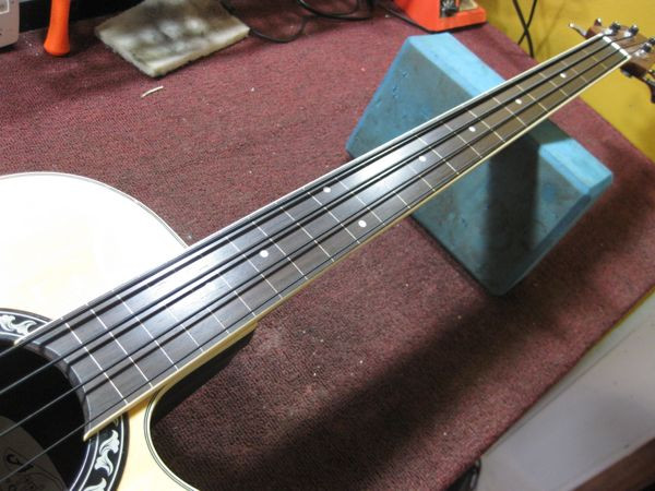 The completed fretless Ovation bass, showcasing the finished fretboard and setup