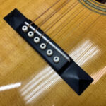 Original right-handed acoustic guitar bridge saddle