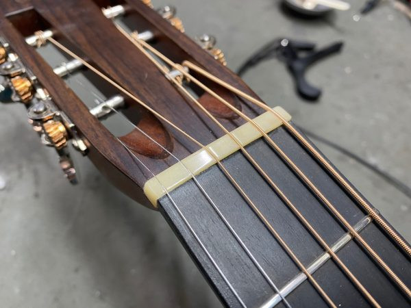 Hand-shaped bone nut and saddle for the left-handed guitar