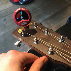 Tuning the guitar with a clip-on tuner