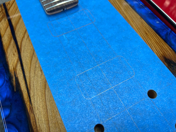 Router carefully cutting the pickup cavity using a template designed for TV Jones pickups, ensuring a precise fit for the electronics.