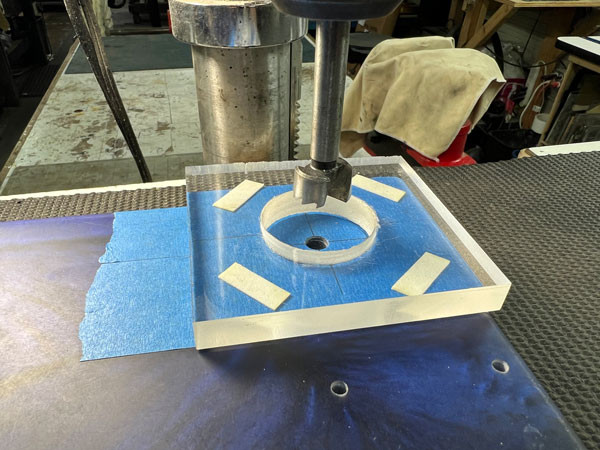 Luthier using a Festool plunge router, a favored tool for precision woodworking and guitar making, to refine cavities in the epoxy body.