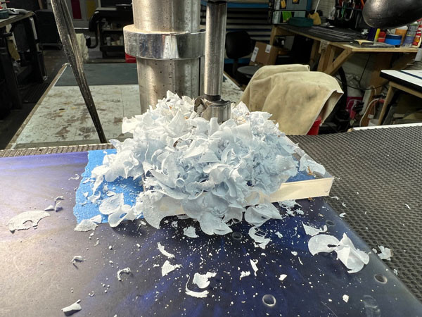 Festool plunge router in action, demonstrating its role in creating clean and accurate routs in the guitar body for electronic components.