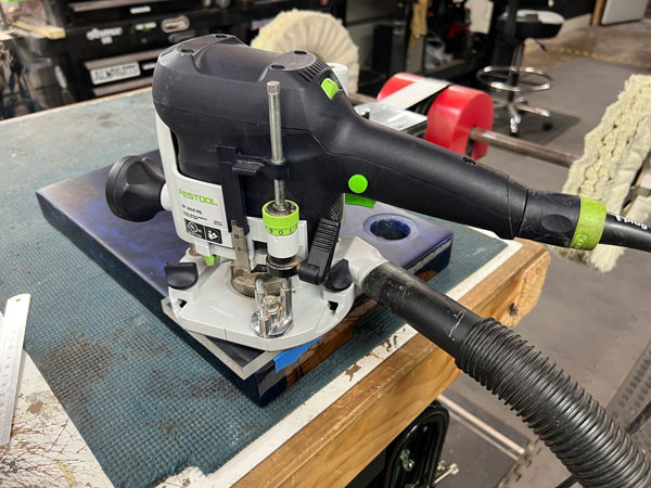 Close-up of the Festool plunge router, highlighting its features and precision capabilities that are essential for guitar building.