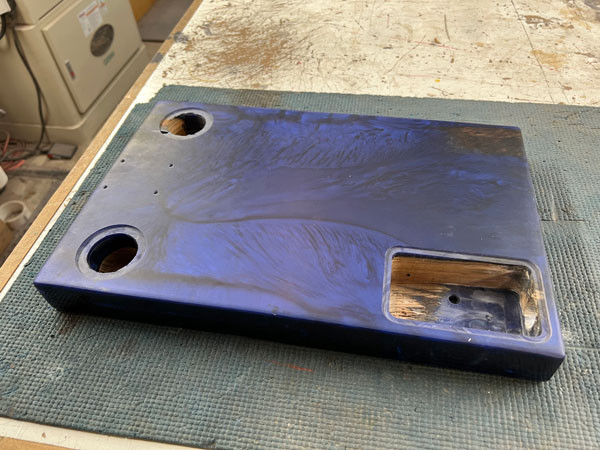 Applying electronic shielding paint to the interior cavities of the guitar body, protecting the electronics from unwanted interference.