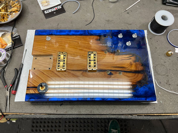 Close-up of the meticulously wired electronics inside the guitar body, showcasing the precision and care taken in the wiring process.