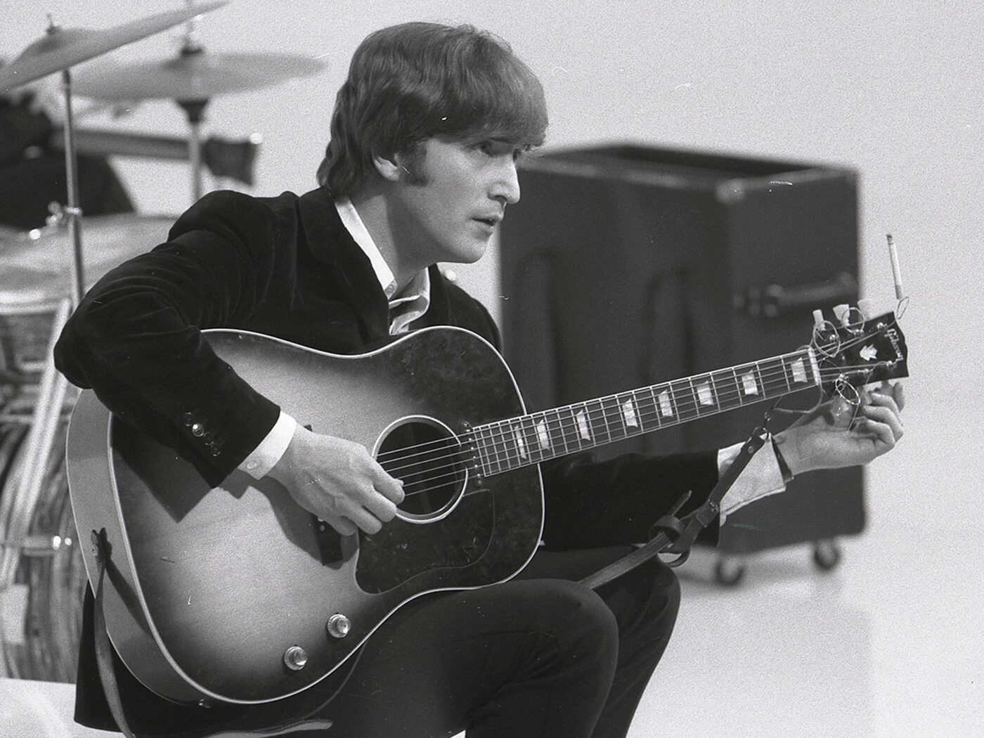 John Lennon tuning his Gibson J-160E guitar