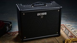 Boss Katana 50 Gen 3 amplifier on a rug with guitar case and cable