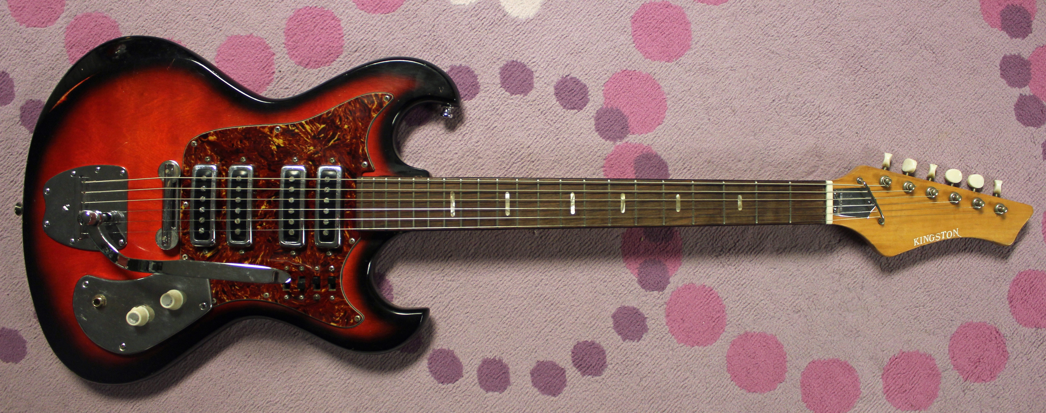 Close-up of the body and pickups of a vintage Kingston S4T guitar, highlighting its classic design and potentially great sounding units.