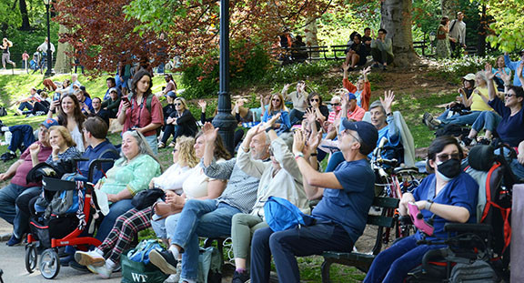 A crowd enjoying an &quot;Opening Day&quot; performance, capturing the lively atmosphere