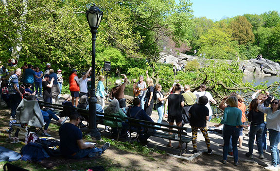 People dancing during an &quot;Opening Day&quot; performance, highlighting the celebratory mood