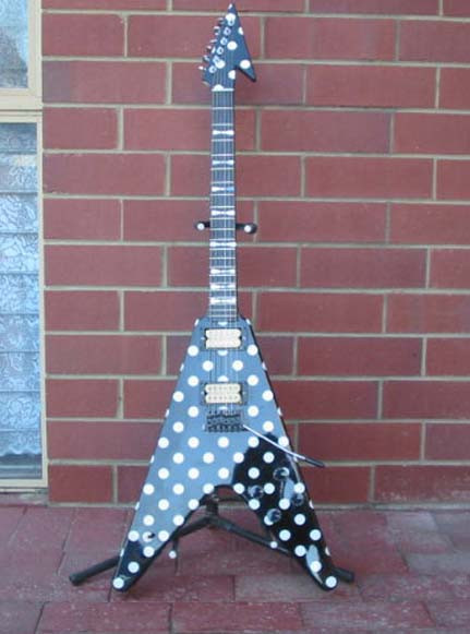Front view of an Ormsby Guitars Polka Dot Flying V guitar with a modern bridge