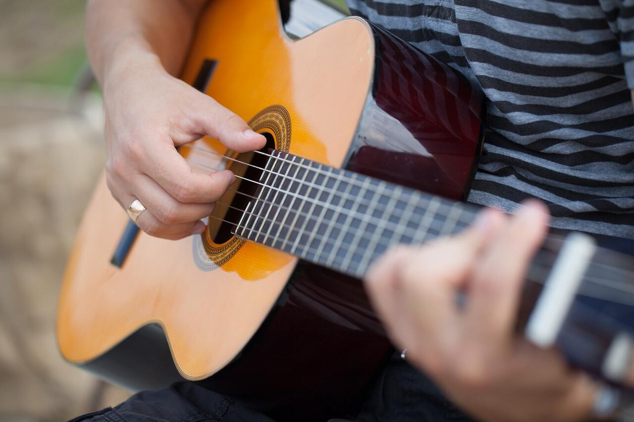 Adult learning to play acoustic guitar
