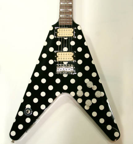 Close up shot of a modern Karl Sandoval Polka Dot Flying V guitar showing the body and polka dot finish