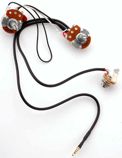 Connecting a GFS Kwik Plug pickup to the wiring harness in a Les Paul guitar, demonstrating the simple plug-and-play installation.