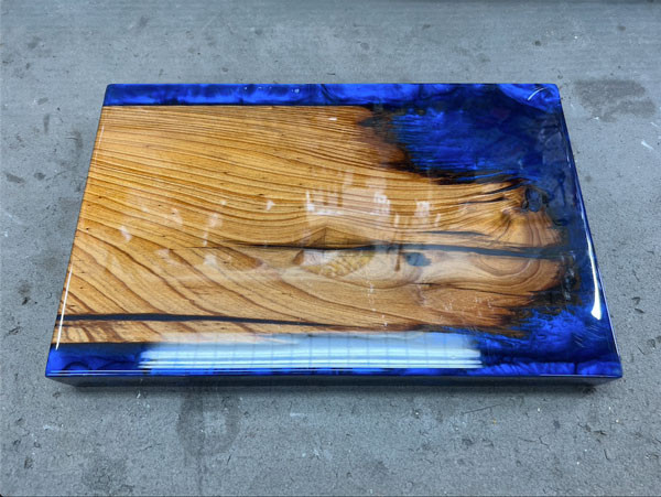 A section of the ancient bald cypress dugout canoe, crafted by the Chitimacha people around 1220 A.D., preserved in epoxy.