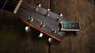 Clip-on tuner on an acoustic guitar headstock