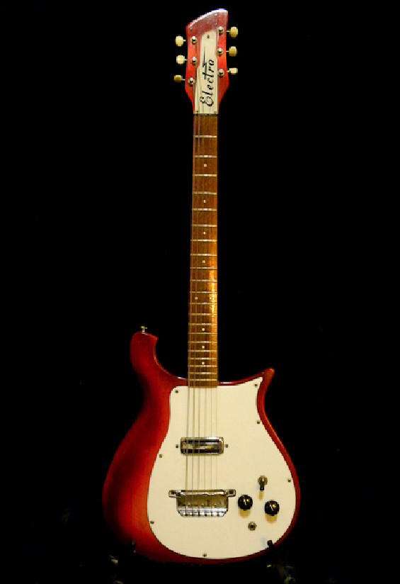 Close-up of the original Fireglo red color under the black paint on the Rickenbacker 425
