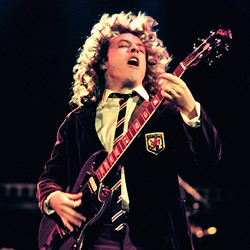 Angus Young iconic schoolboy outfit and energetic stage presence