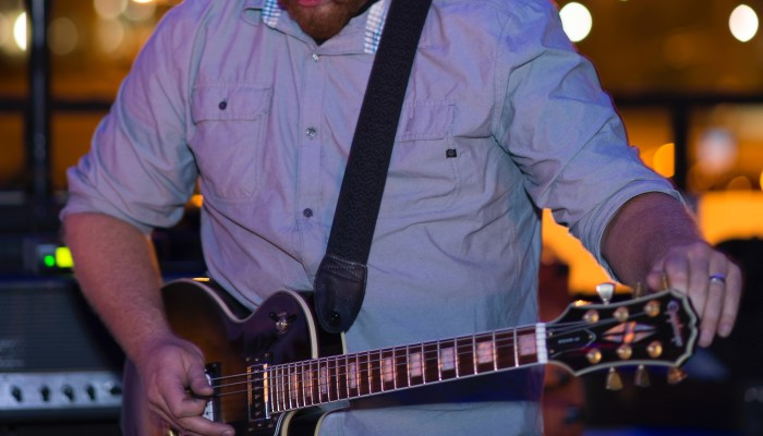 Guitarist tuning up his electric guitar