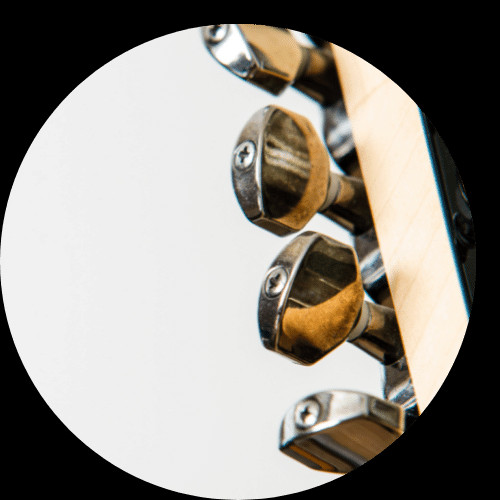 Close up of tuning pegs on an electric guitar headstock