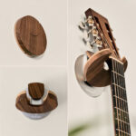 Acoustic guitar mounted on a wooden wall with HangWithMe guitar wall mount, showcasing a natural wood finish and minimalist design.