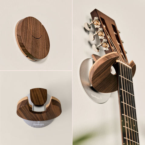 Acoustic guitar mounted on a wooden wall with HangWithMe guitar wall mount, showcasing a natural wood finish and minimalist design.