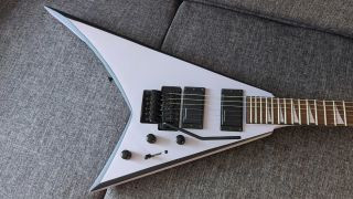 Close-up angled shot of the body of a black Jackson X Series Rhoads RRX24 electric guitar