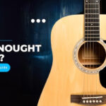 Close-up of a dreadnought acoustic guitar body, highlighting its iconic shape.