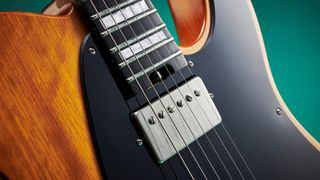 Close-up of the neck humbucker on a Charvel Joe Duplantier signature model electric guitar