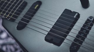 Close-up of an EMG active humbucker pickup on a Peavey electric guitar